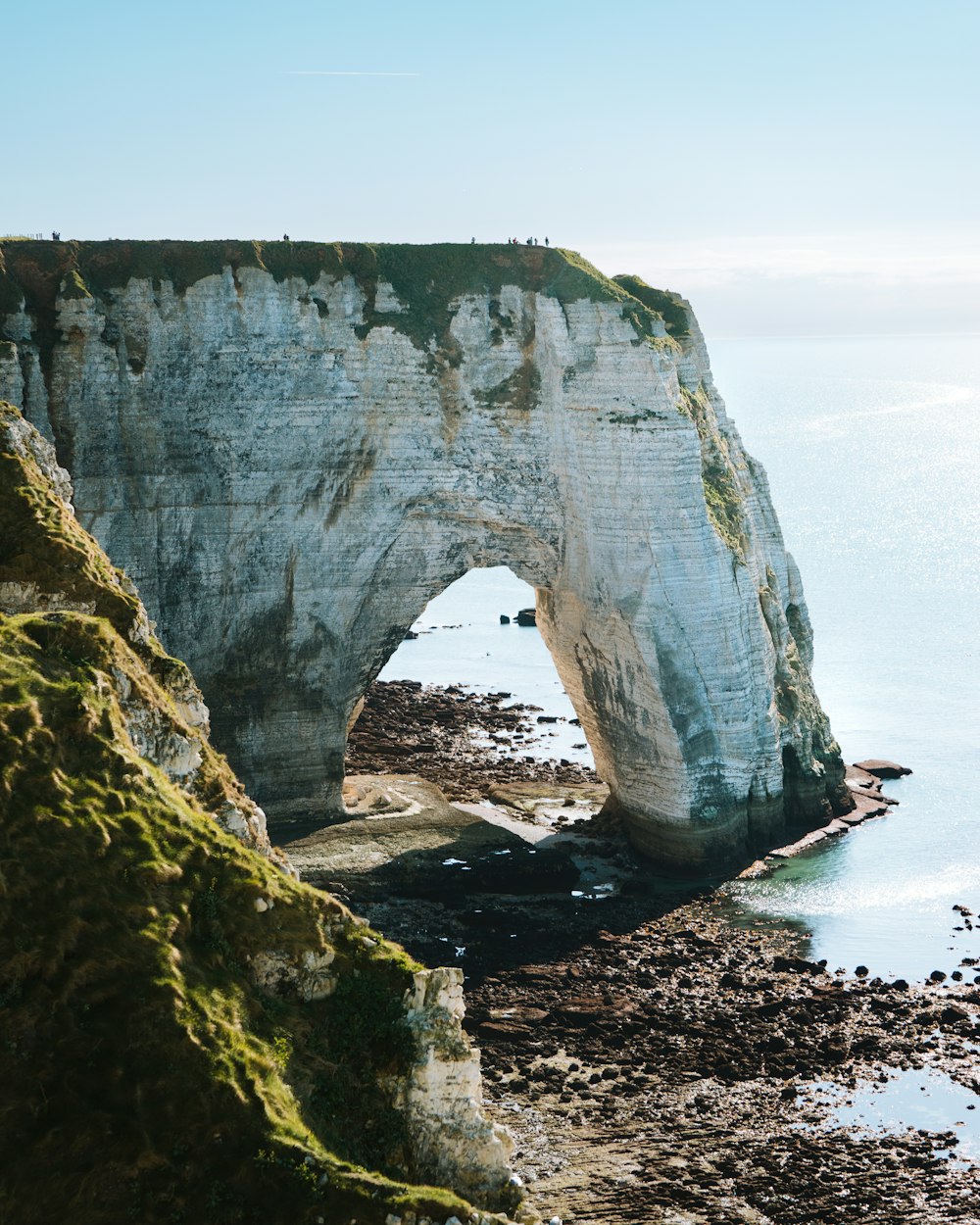 a large white rock formation near the ocean