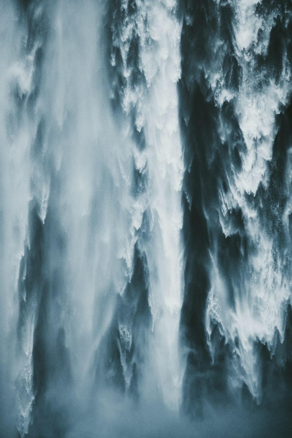 a very large waterfall with water coming out of it