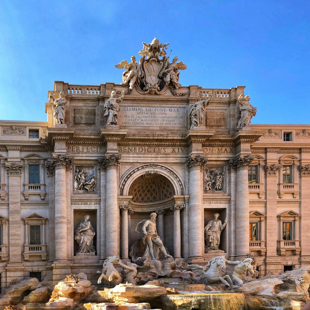 un grande edificio con una fontana di fronte ad esso