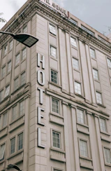 a large tall tower with a clock on the side of a building