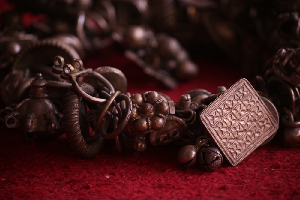 a close up of a bracelet on a red surface