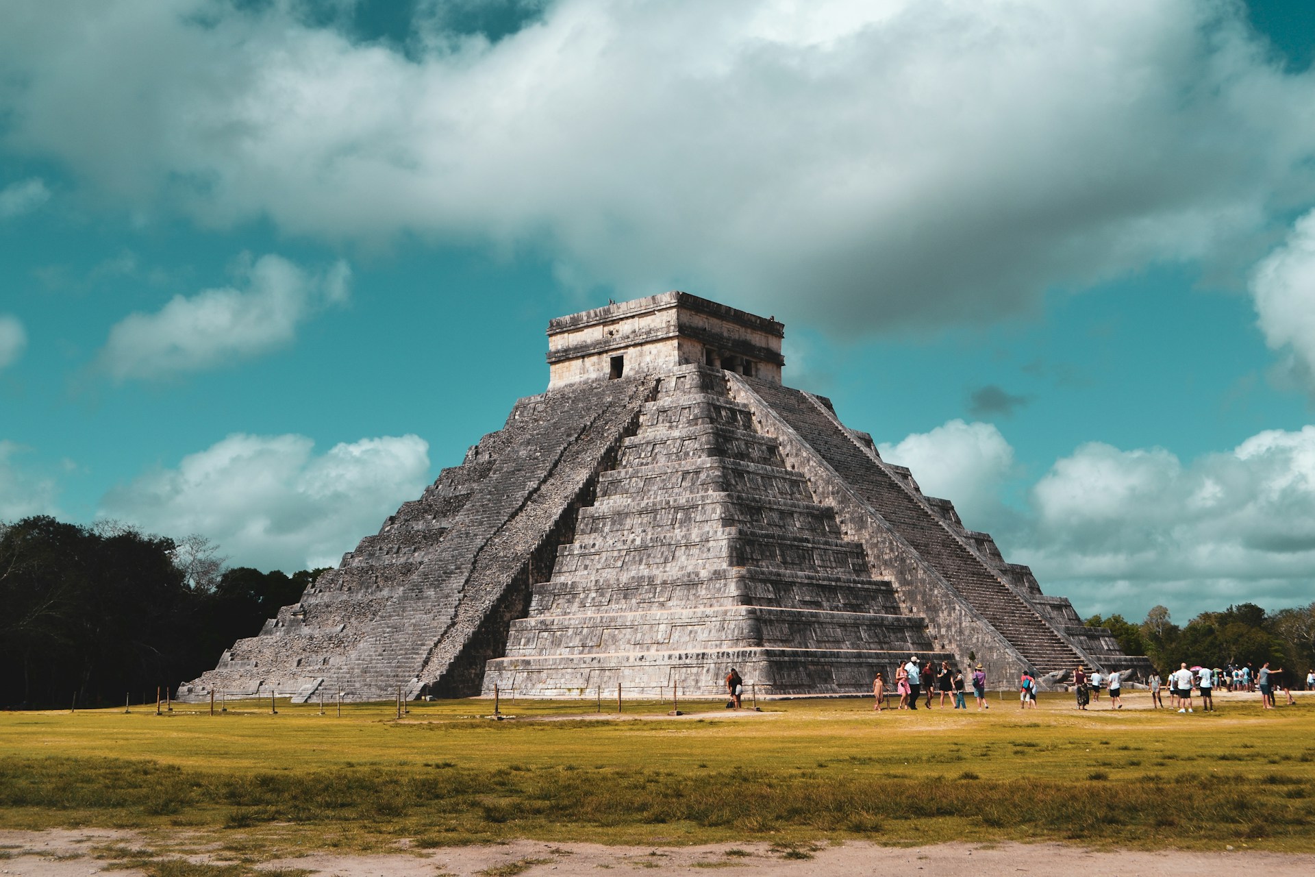 a group of people standing in front of a pyramid