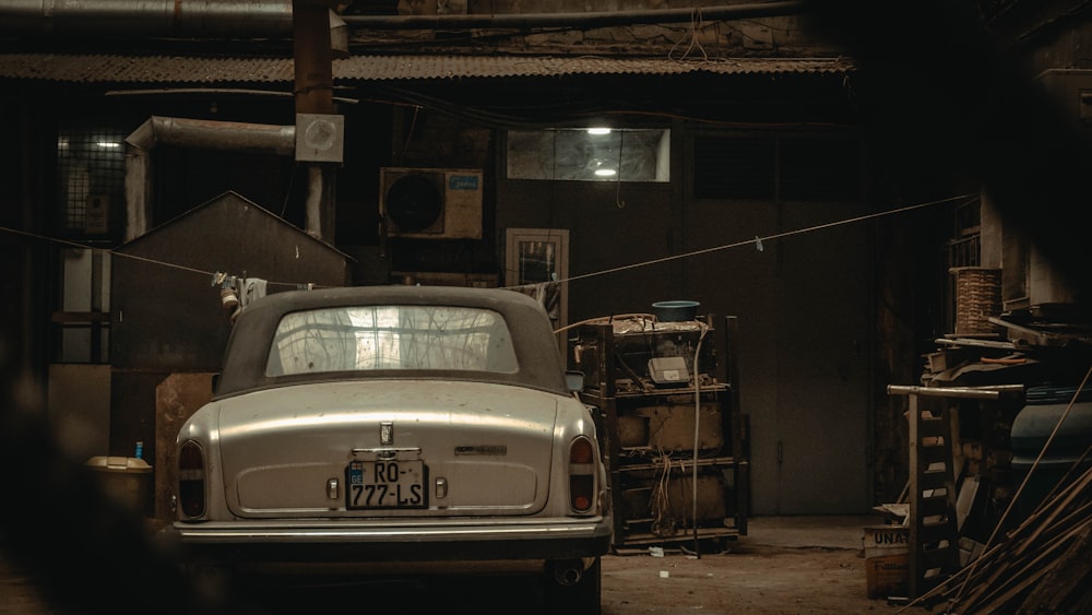 an old car is parked in a garage
