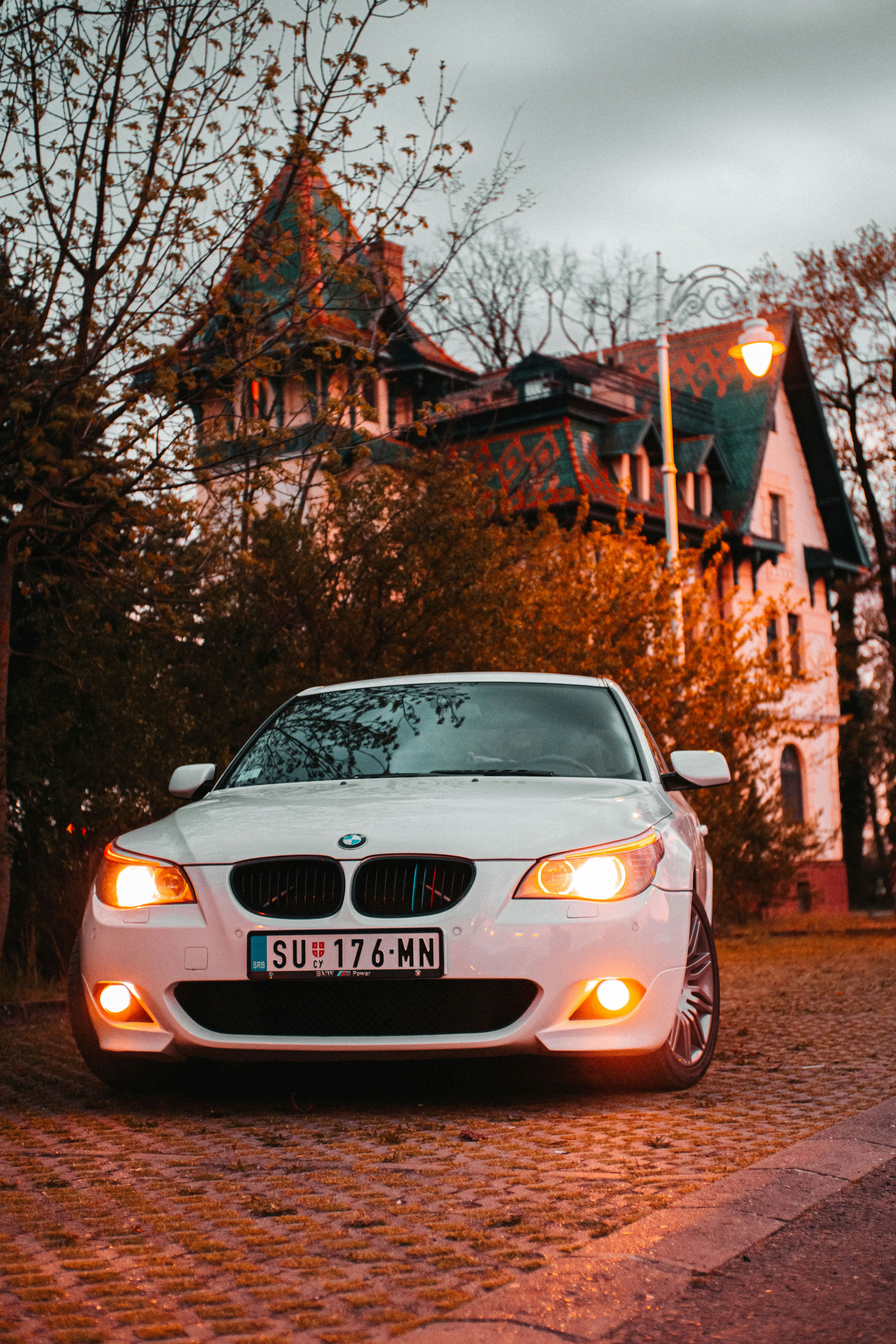 a white car parked in front of a house