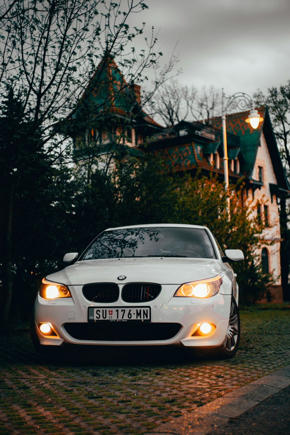 um carro branco estacionado em frente a uma casa