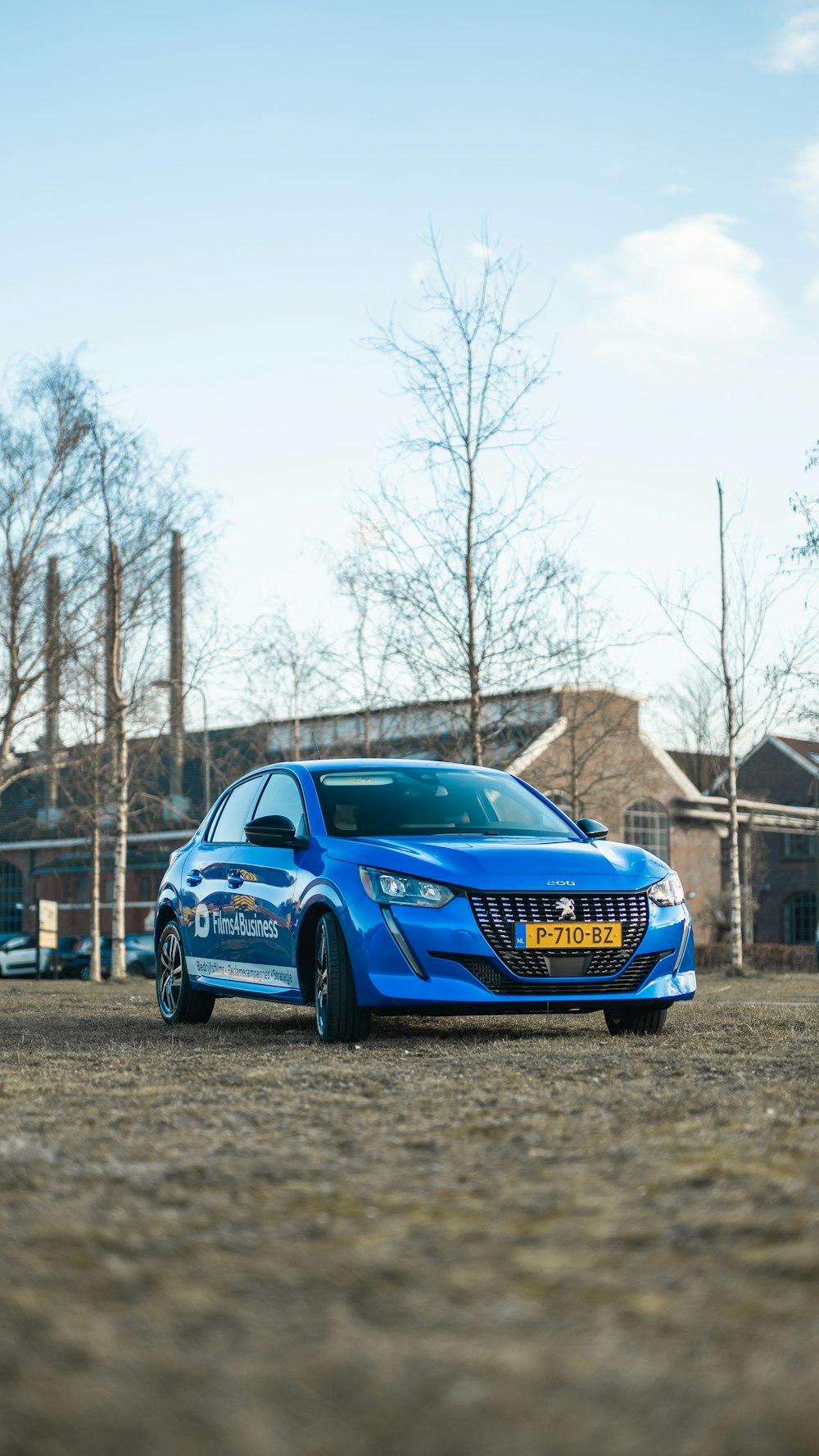 a blue car parked in a parking lot