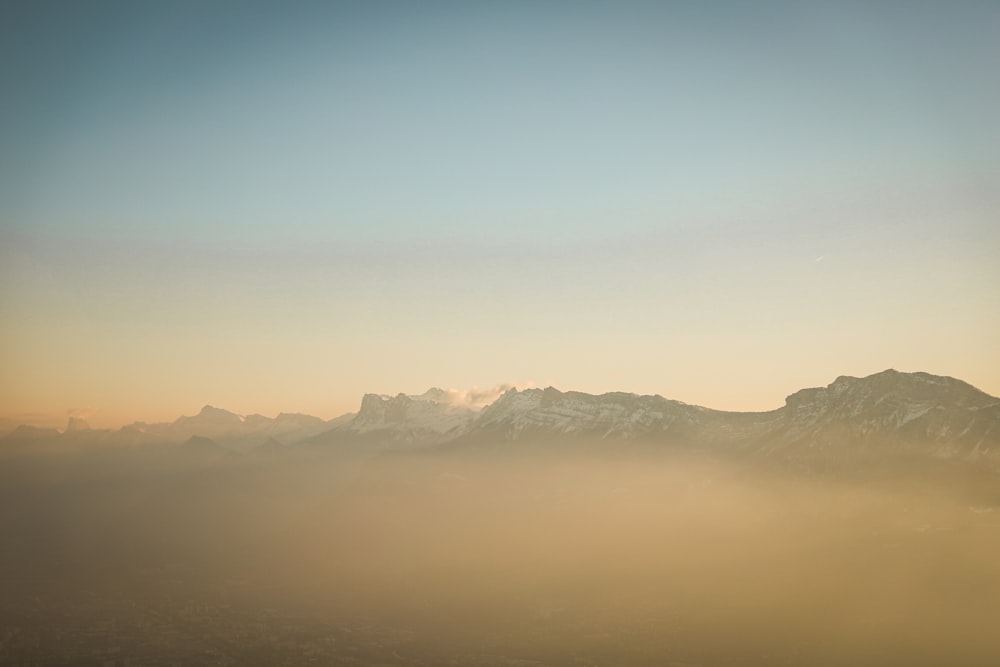 a view of a mountain range covered in fog