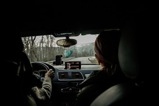 a woman driving a car in the dark
