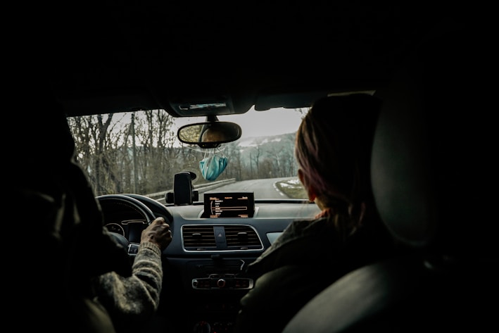 a woman driving a car in the dark