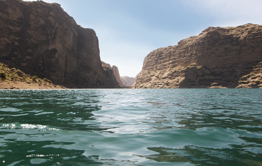 a body of water surrounded by rocky cliffs