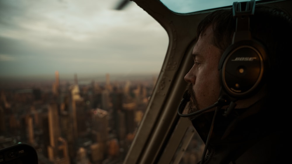 a man in a helicopter with headphones on