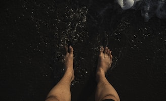 Close-up of bare feet gently touching natural earth, symbolizing grounding.