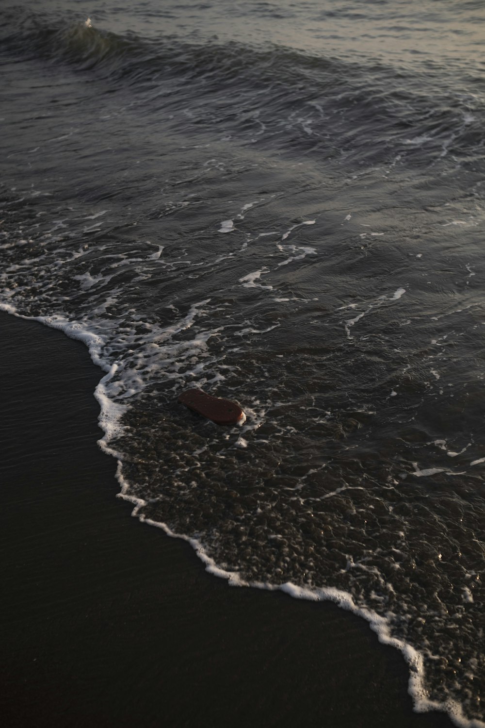 a beach with waves coming in to shore