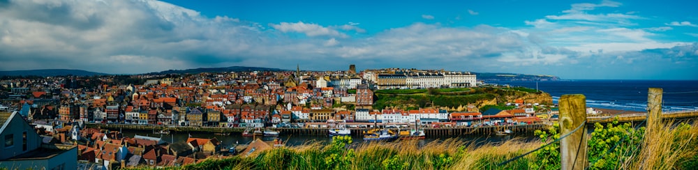 a view of a city from a hill overlooking the ocean