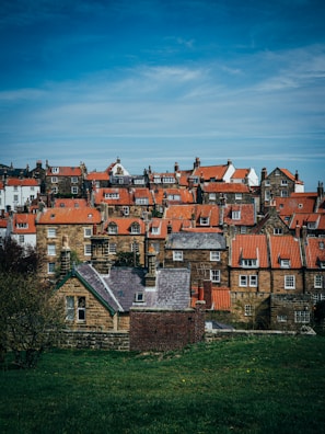 A cozy village scene from Pixelshire with pixel art houses and villagers.