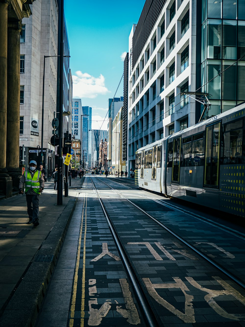 a city street with a train on the tracks