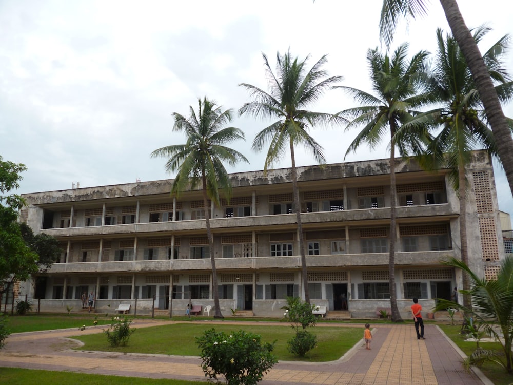 a large building with palm trees in front of it