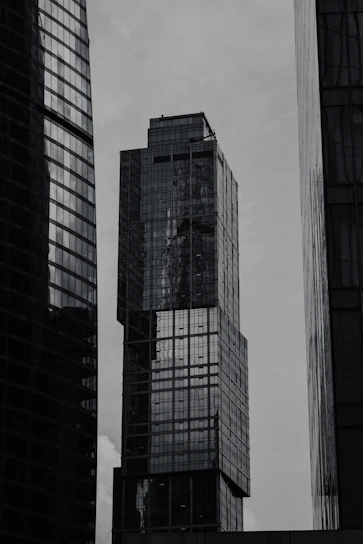 a black and white photo of skyscrapers in a city