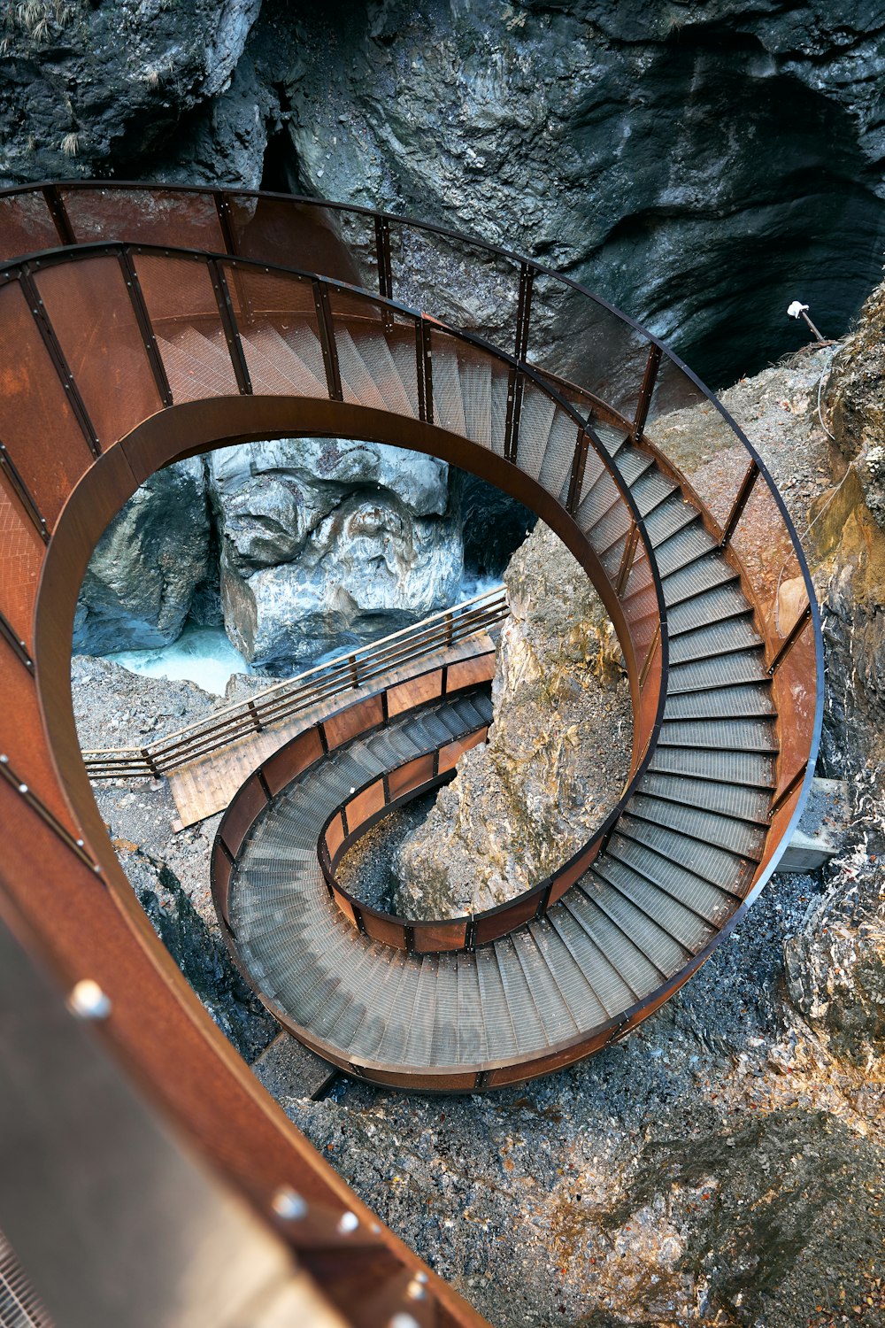 a spiral staircase going up to a cave