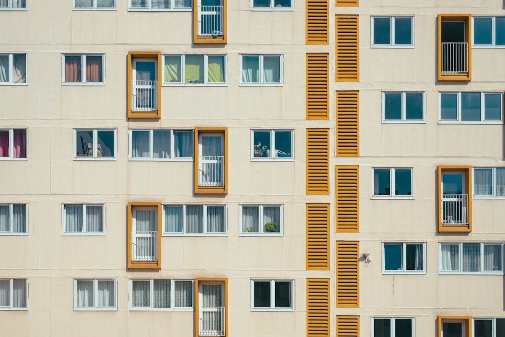 a very tall building with many windows and shutters