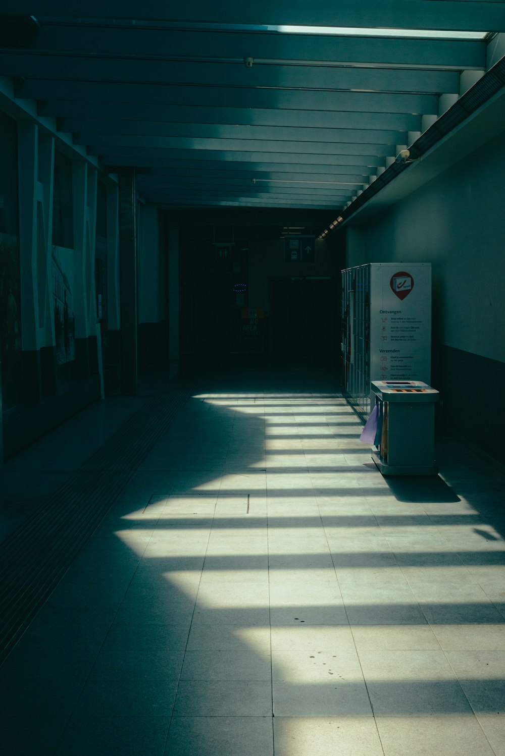 a long hallway with long shadows on the floor