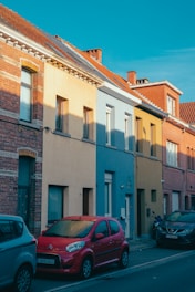 a red car parked on the side of a street
