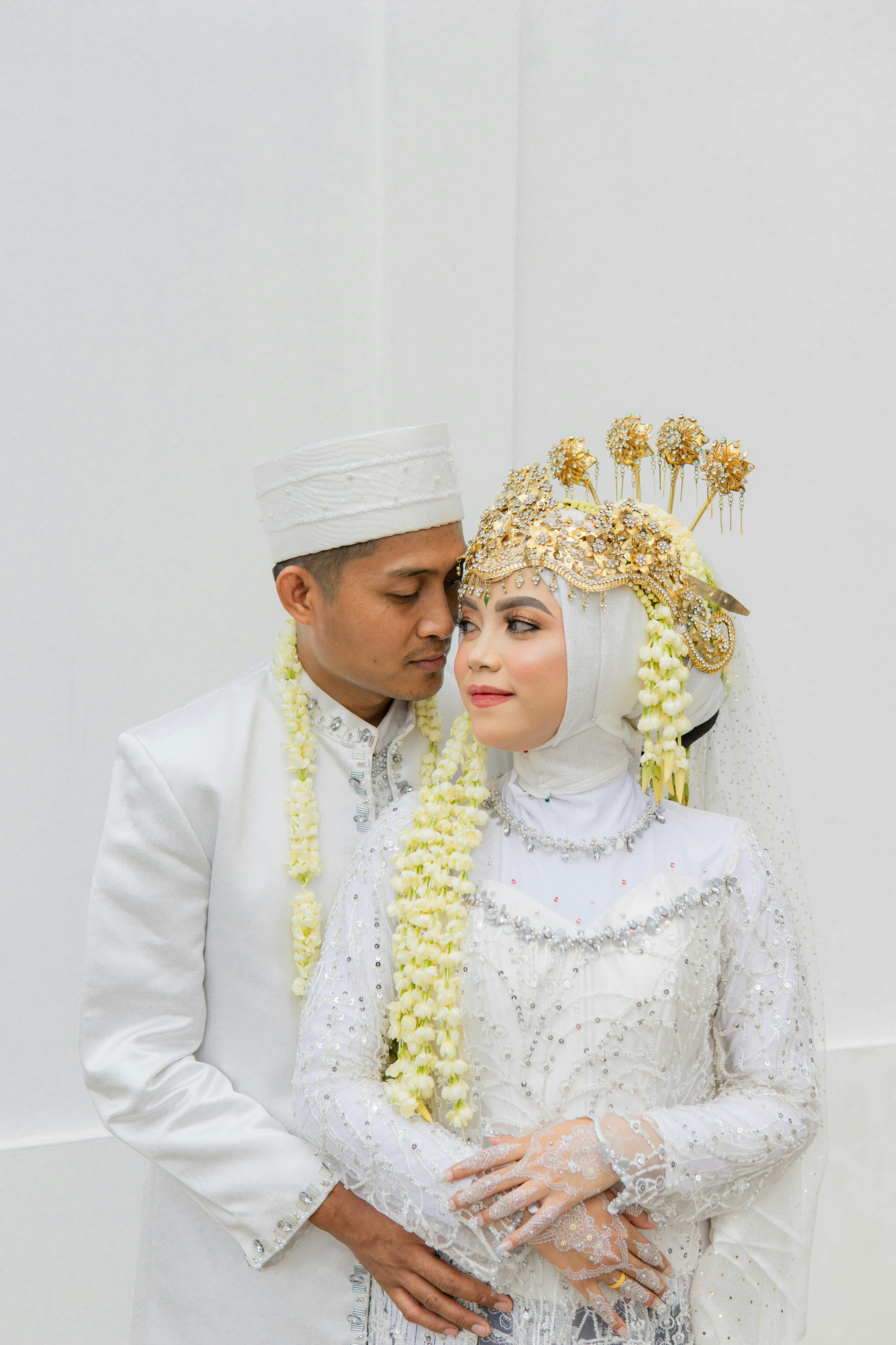 a man and a woman dressed in wedding attire