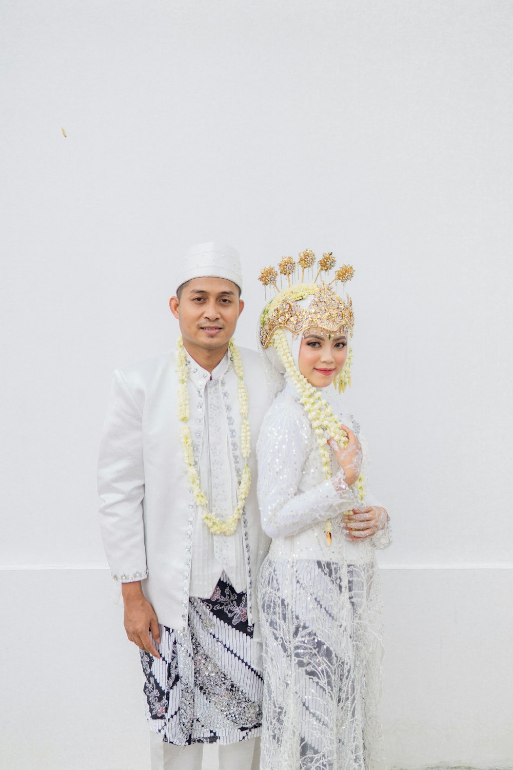 a man and a woman dressed in traditional thai garb