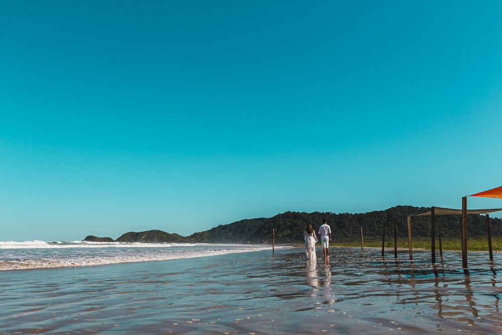 a couple of people that are standing in the water