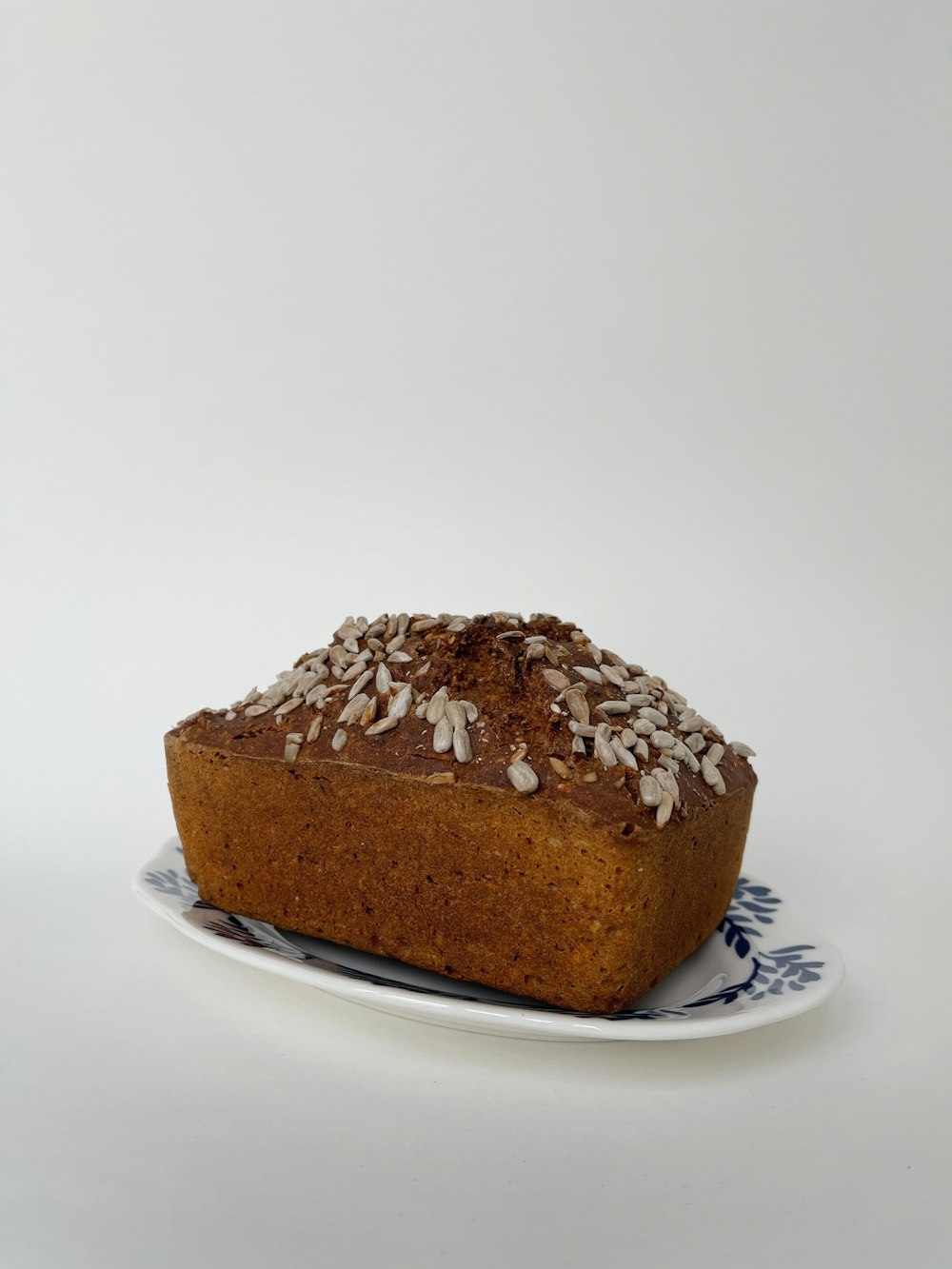 a loaf of bread on a blue and white plate