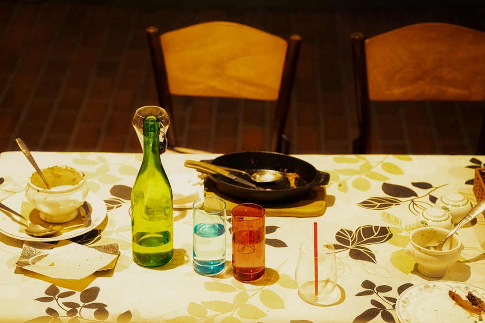 a table topped with a bottle of wine next to a plate of food