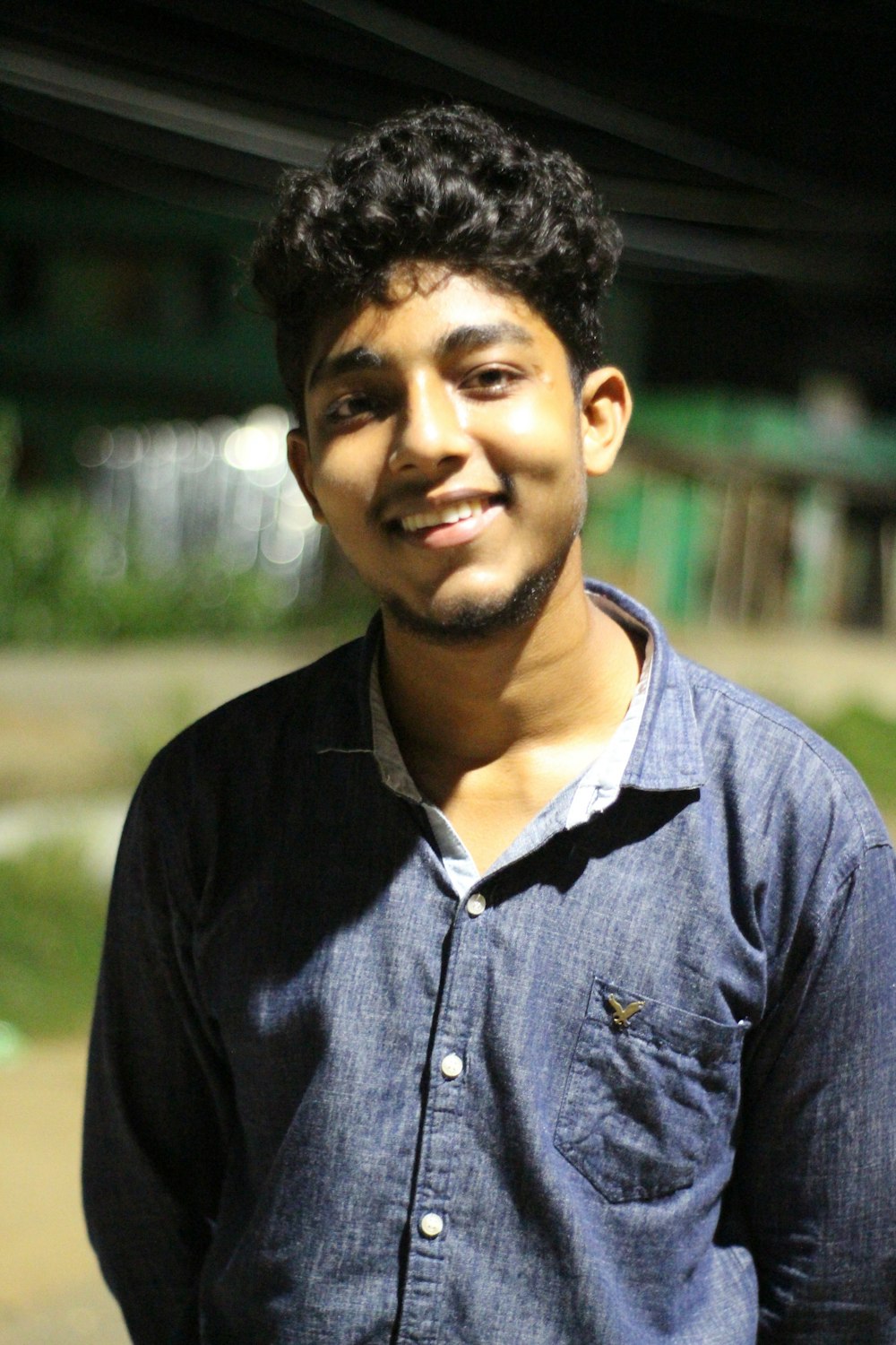 a young man is smiling at the camera