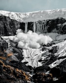 a mountain with a waterfall coming out of it