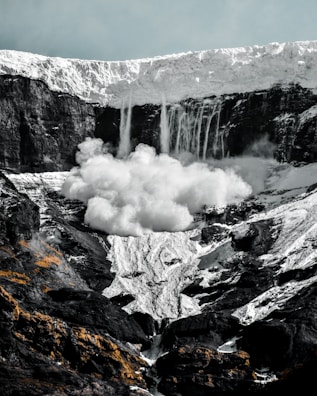 a mountain with a waterfall coming out of it