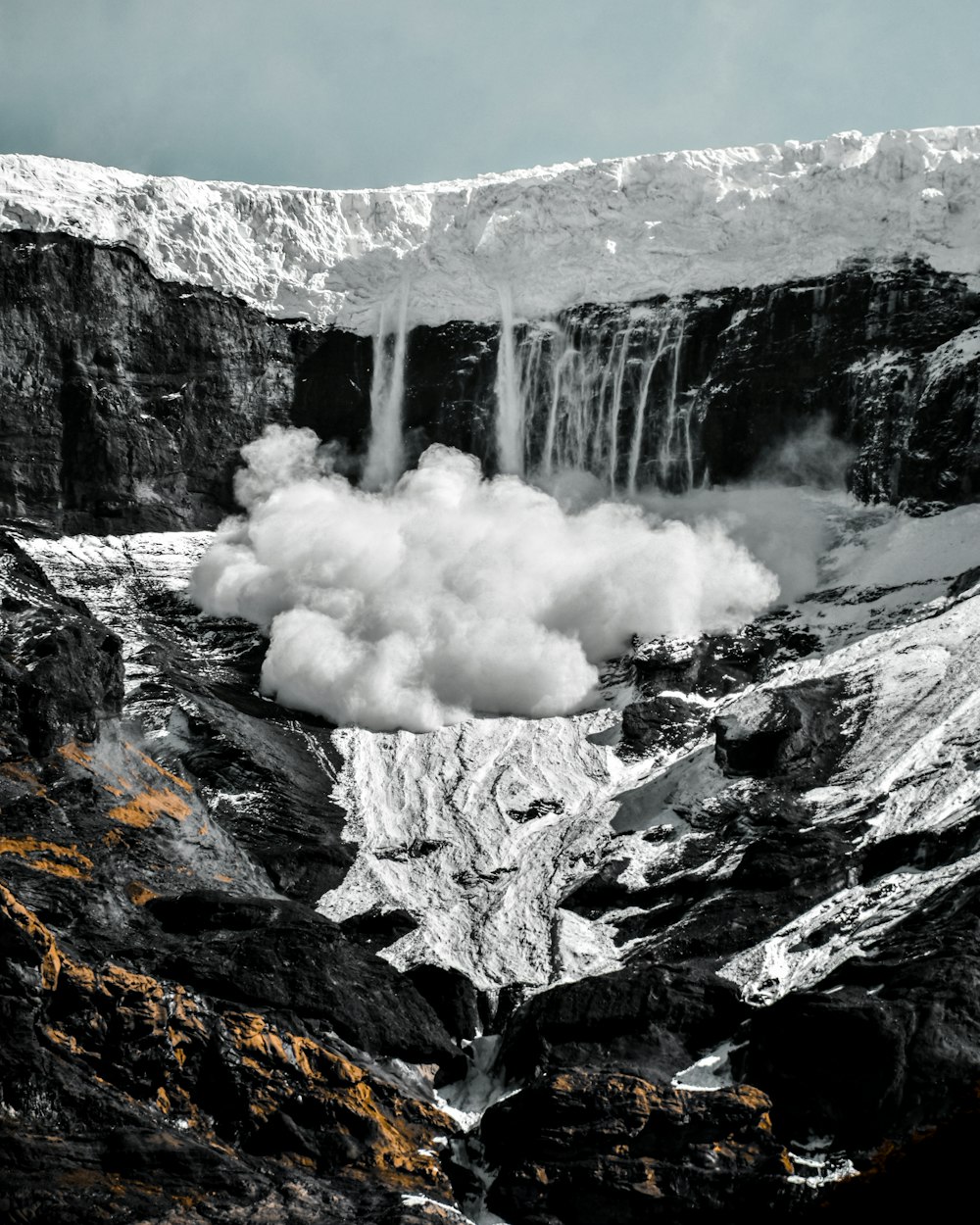 a mountain with a waterfall coming out of it