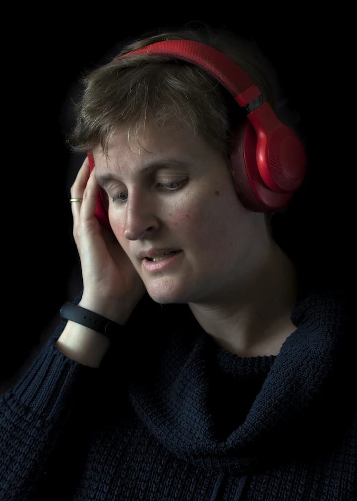 Woman wearing headphones, listening