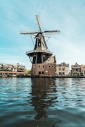 a windmill sitting on top of a body of water