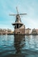 a windmill sitting on top of a body of water