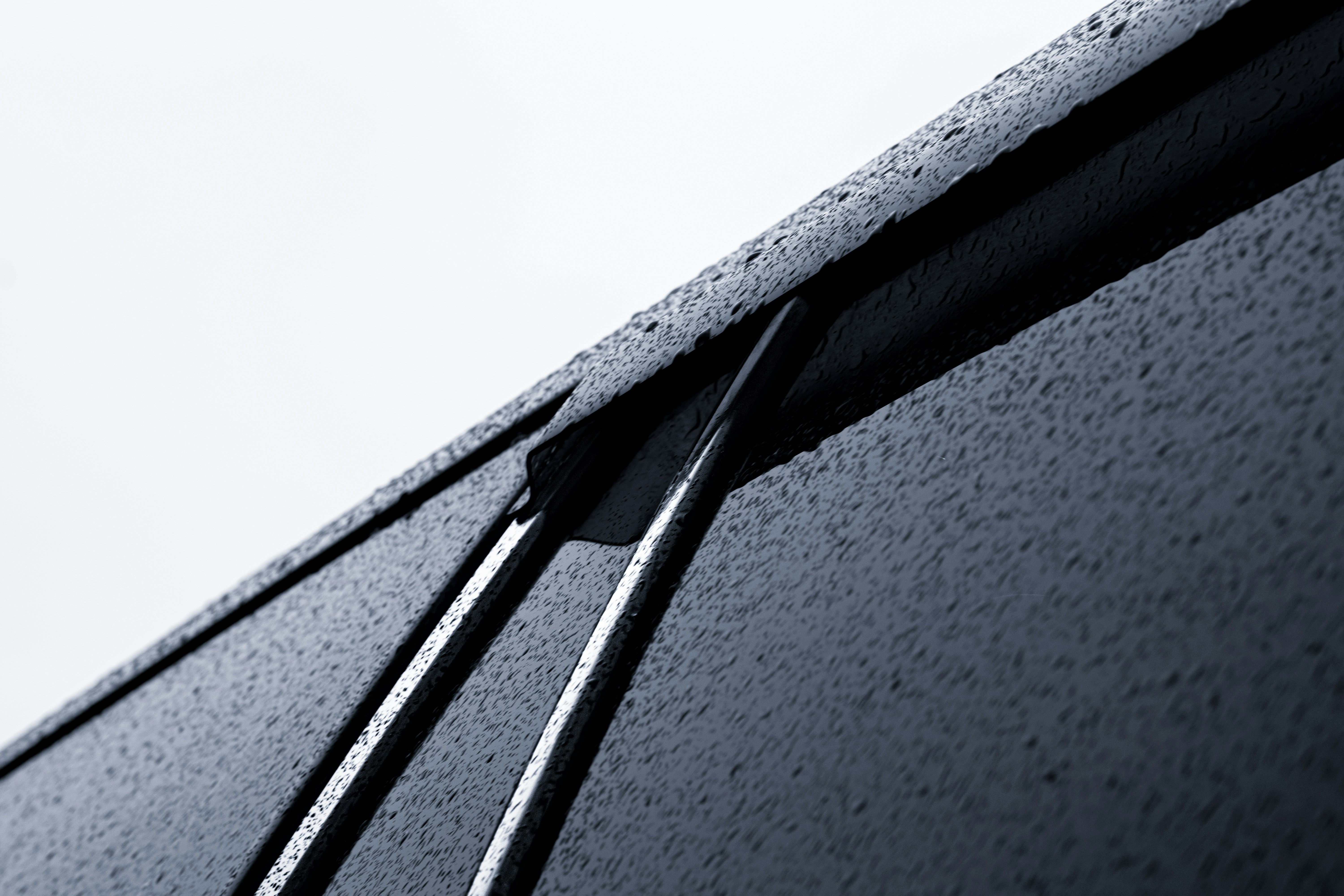 a close up of a black refrigerator with water droplets on it