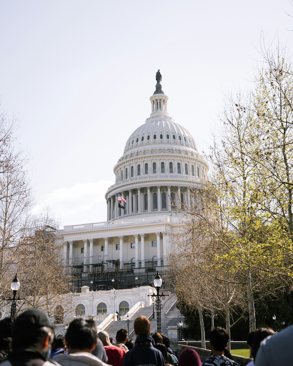 a crowd of people standing in front of the capitol building