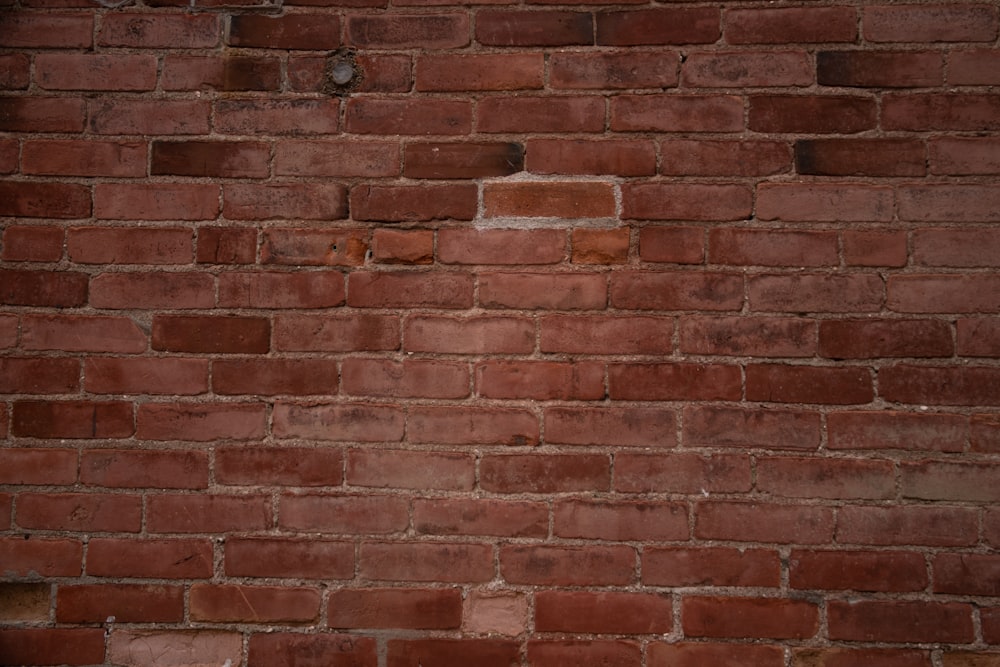 a close up of a brick wall with no mortar