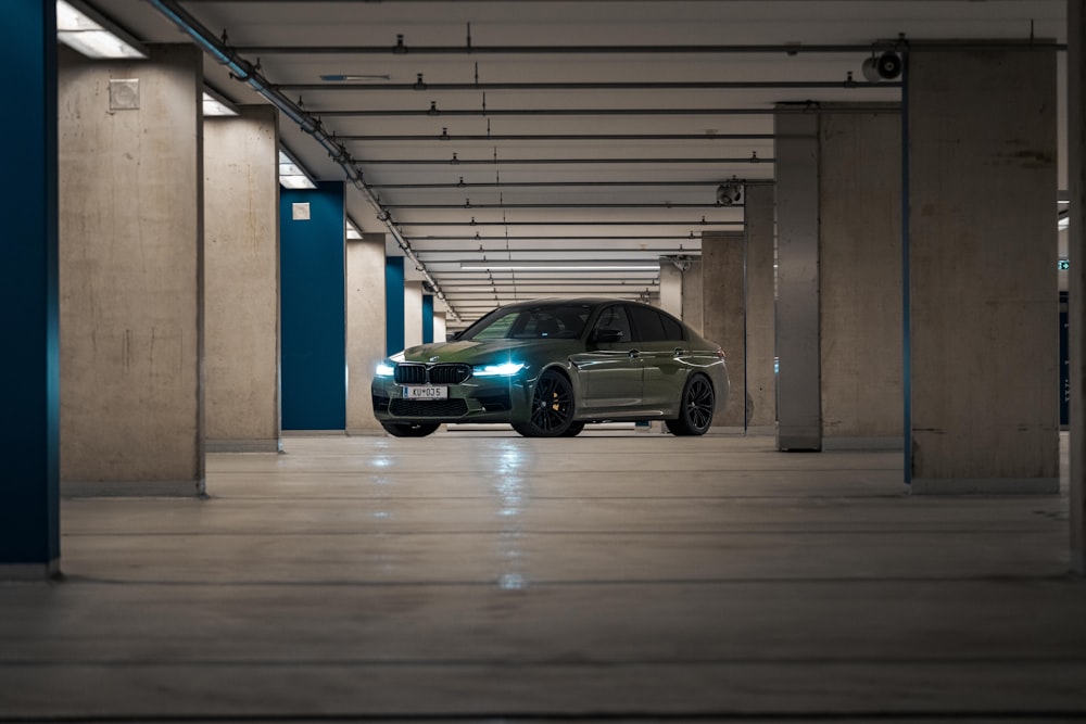 a green car parked in a parking garage