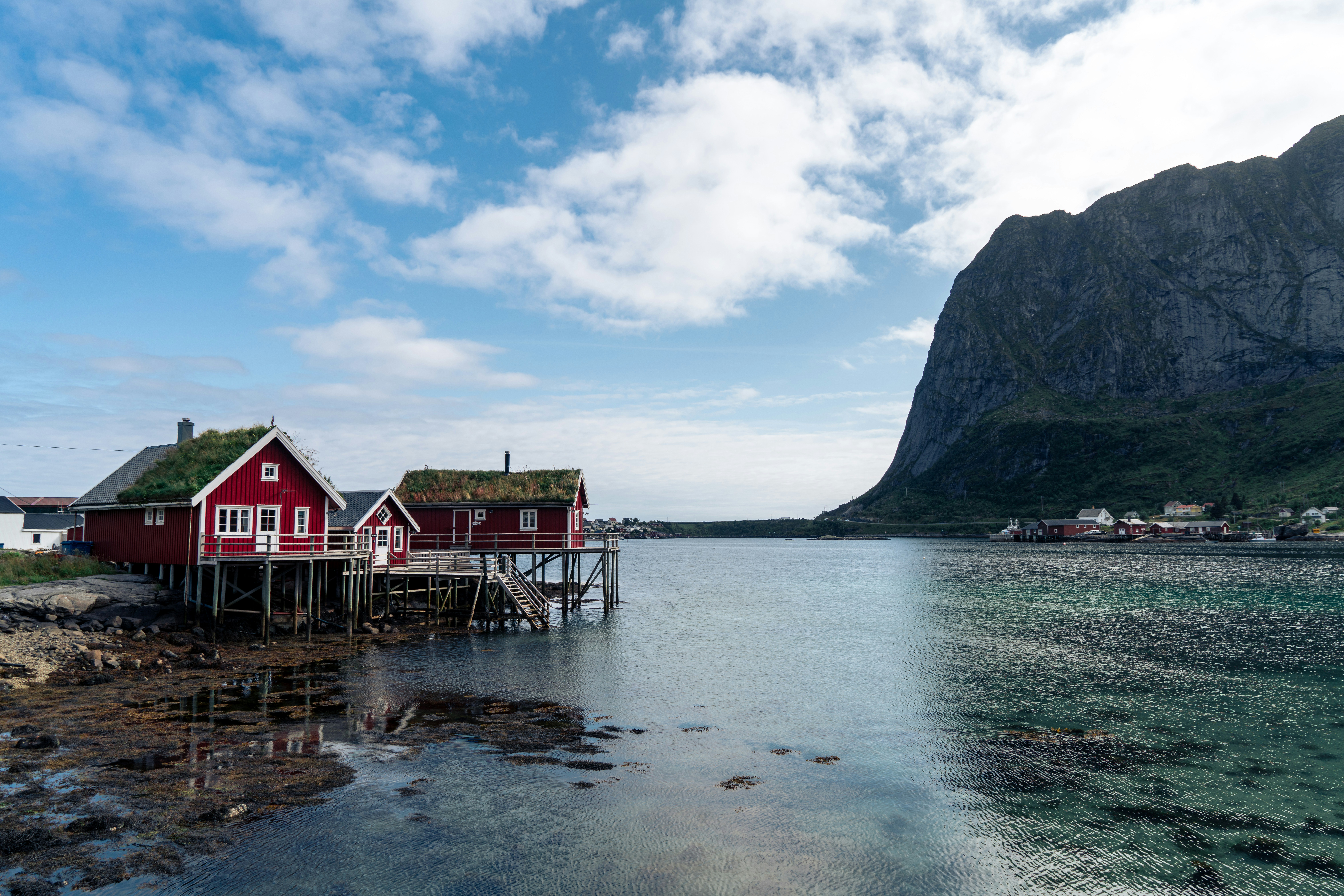 a red house sitting on top of a body of water