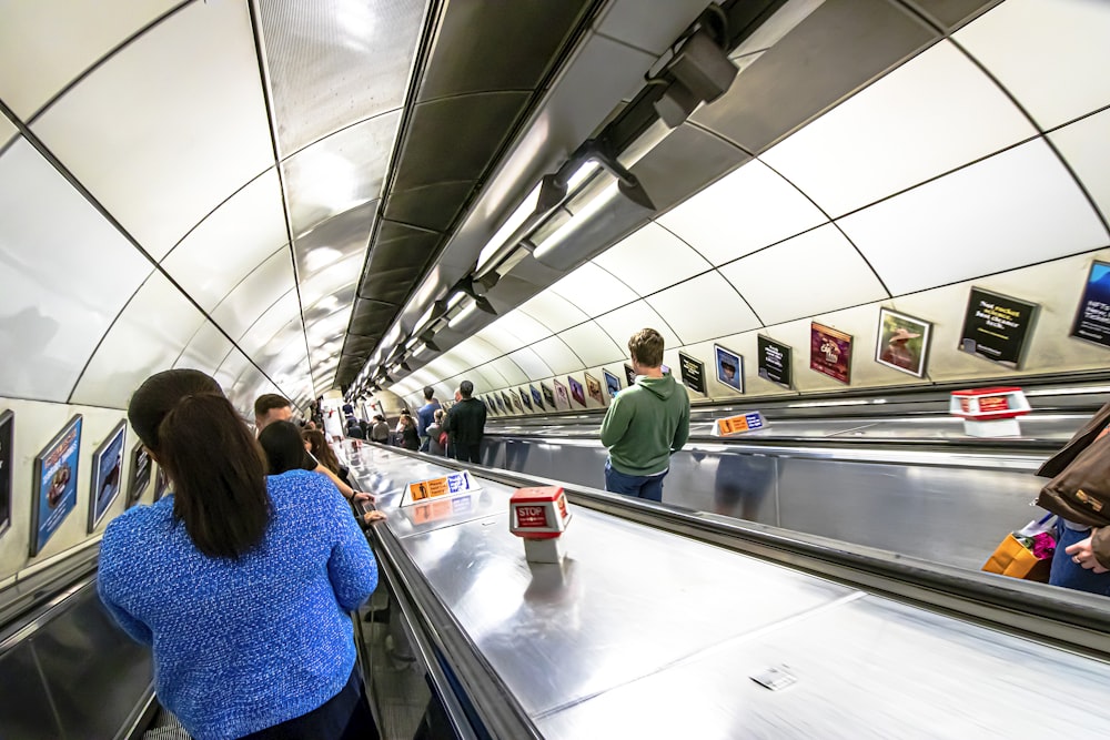 a group of people riding down an escalator