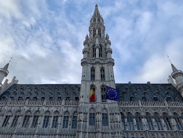 A detailed map highlighting Belgium with its national flag and a famous landmark.