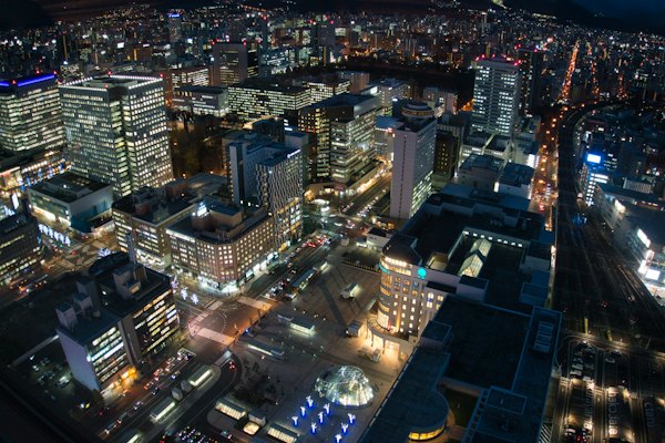 An aerial view of a city at night — Sapporo, Japan