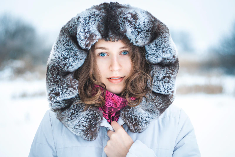 Glamorous sugar baby in a fur hat in the snow