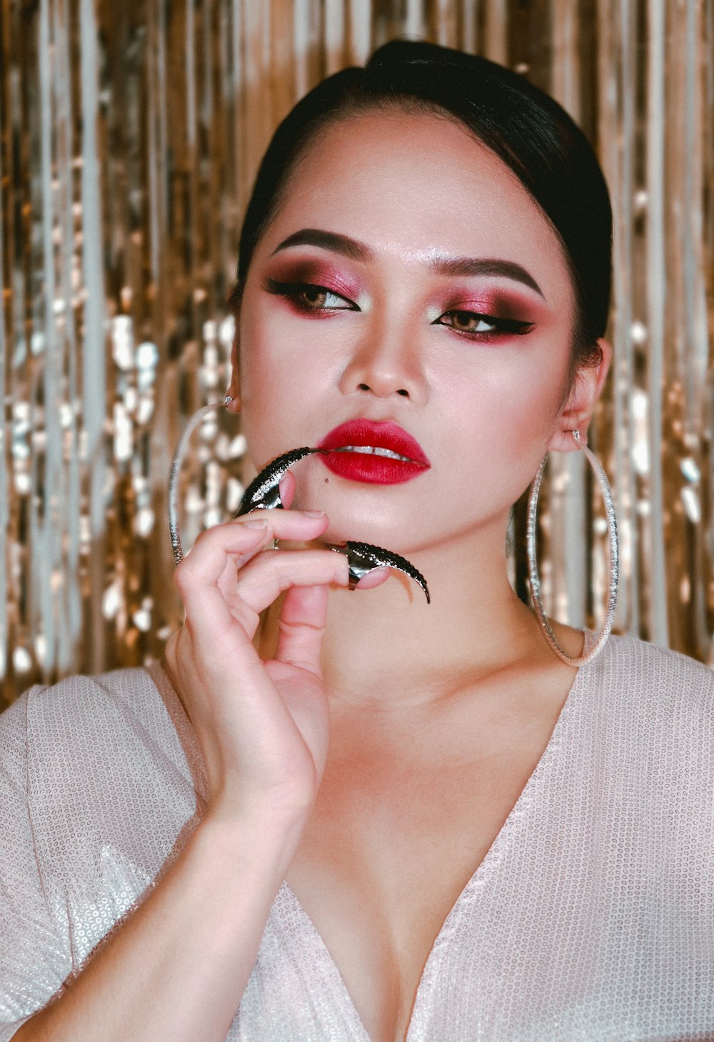 a woman with red lipstick and a spider on her face