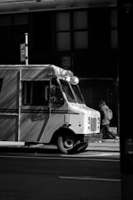 a black and white photo of a food truck