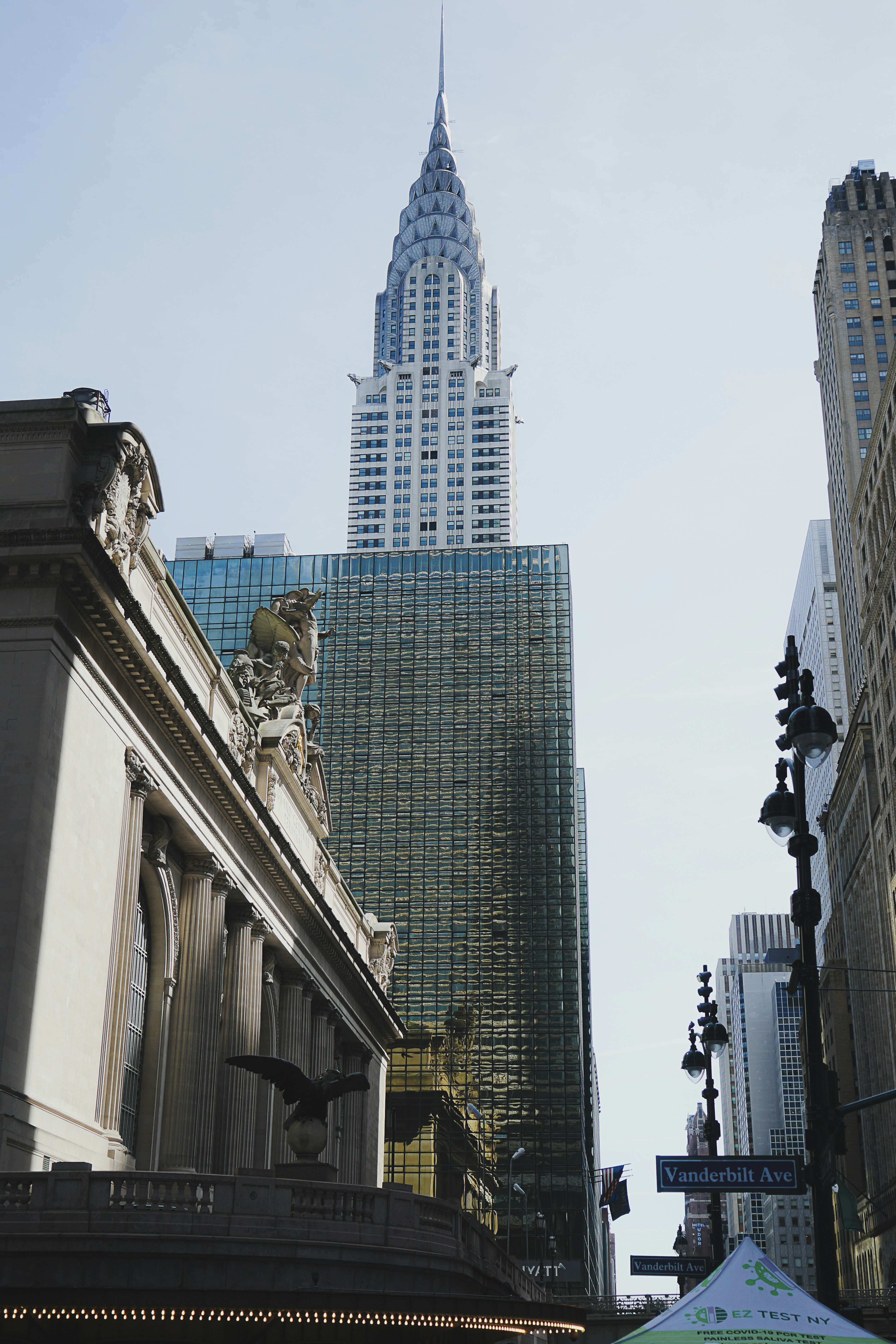 a city street with tall buildings in the background